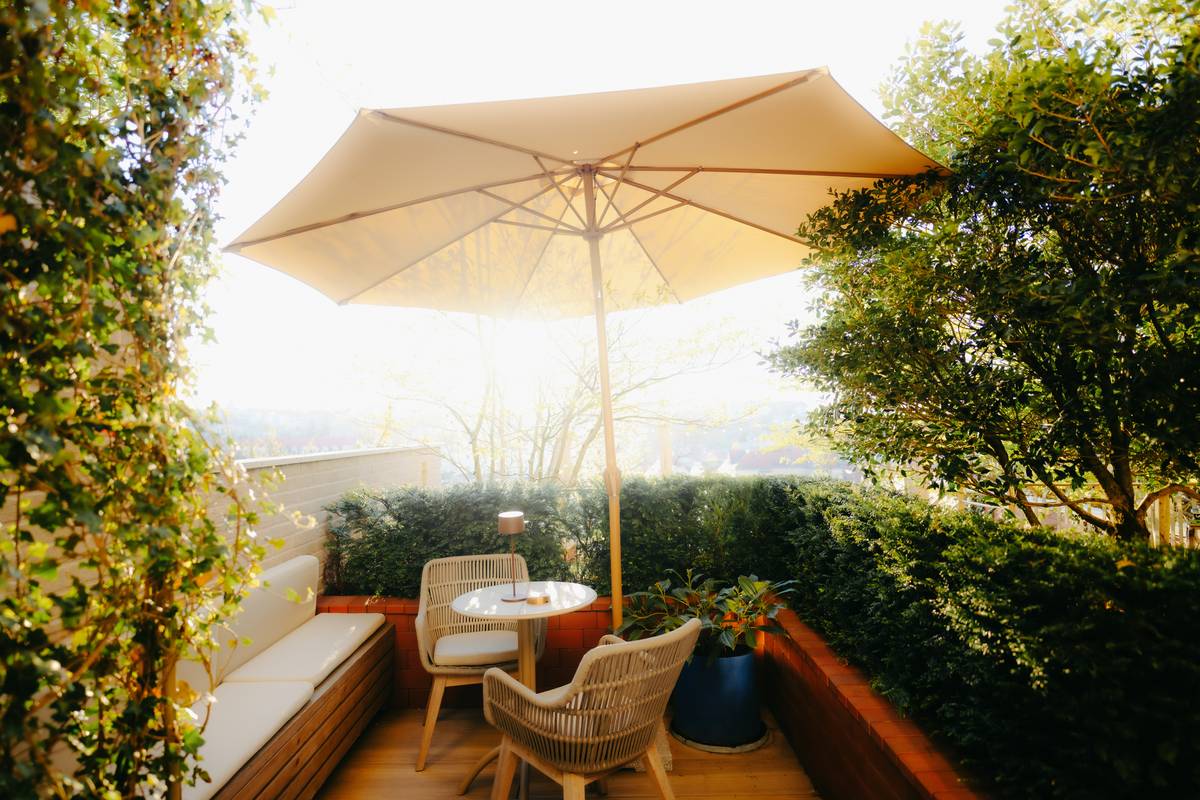 Sturdy garden outdoor umbrella with aluminum frame and polyester canopy over a patio table