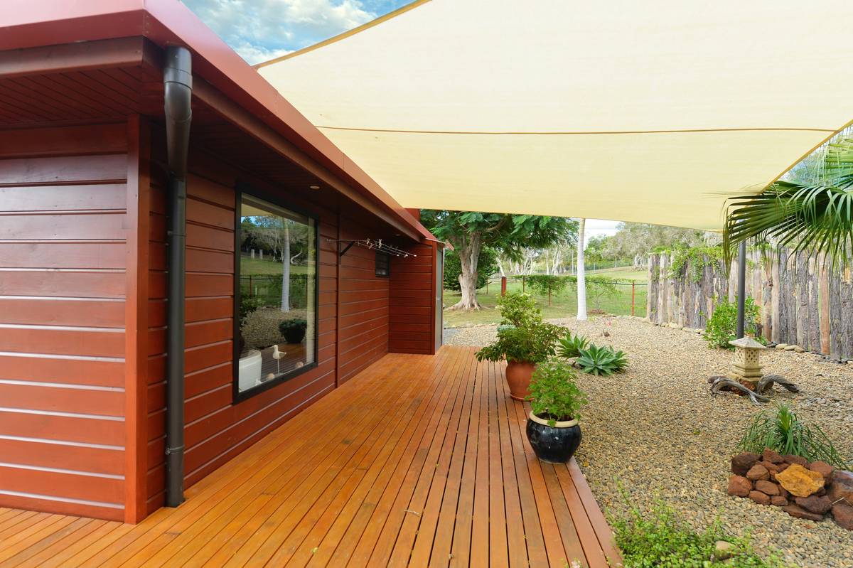 decorative item market umbrella patio what - modern aluminum-framed market umbrella with vented canopy over teak patio set