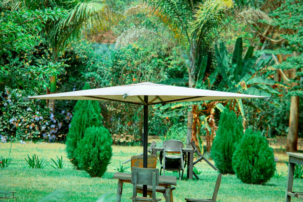 treasure garden market umbrella canada installed on a wooden patio with stone base and Sunbrella canopy